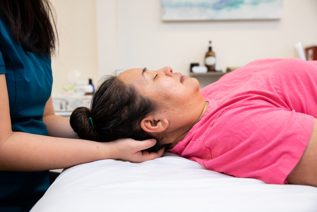 Photo of provider performing craniosacral therapy at a patient's head