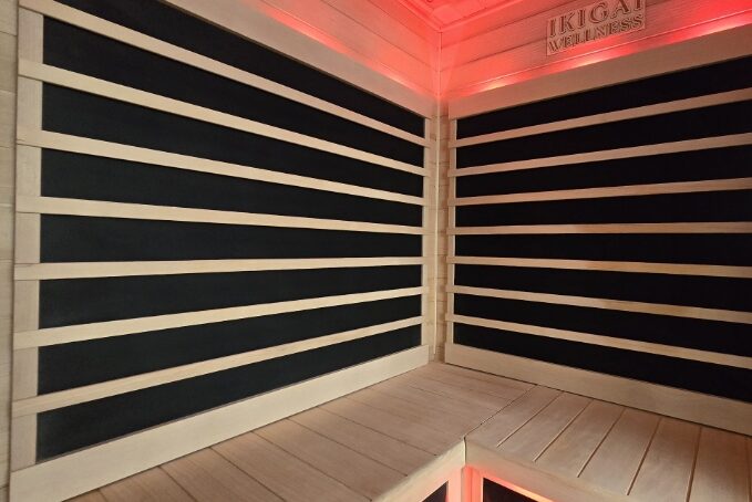 wooden seating bench with infrared panels along the walls of a sauna