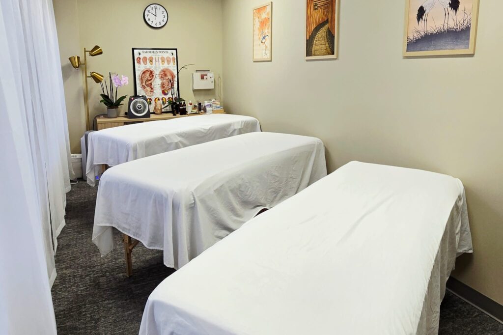 three treatment tables lined up in a room